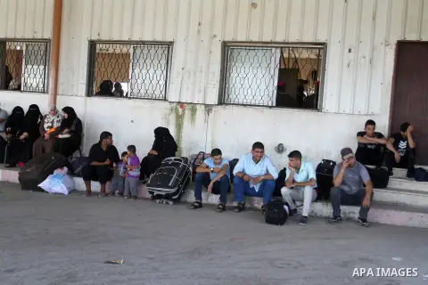 Palestinians wait for a travel permit to cross into Egypt through the Rafah border crossing after it was opened by Egyptian authorities for five days, in the southern Gaza Strip June 30, 2016. Photo by Abed Rahim Khatib