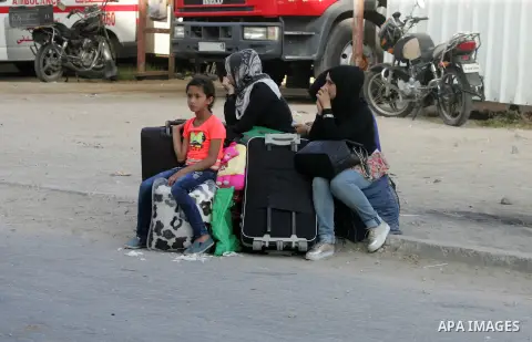 Palestinians wait for a travel permit to cross into Egypt through the Rafah border crossing after it was opened by Egyptian authorities for five days, in the southern Gaza Strip June 30, 2016. Photo by Abed Rahim Khatib