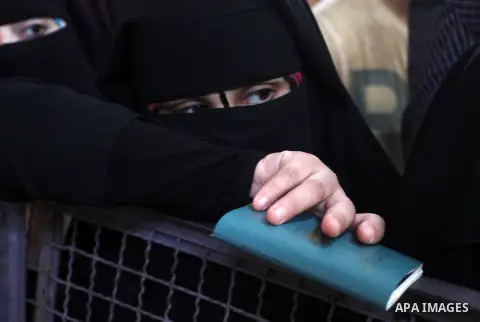 Palestinians wait for a travel permit to cross into Egypt through the Rafah border crossing after it was opened by Egyptian authorities for five days, in the southern Gaza Strip June 30, 2016. Photo by Abed Rahim Khatib