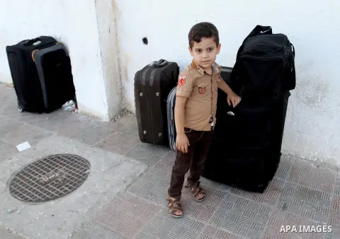 Palestinians wait for a travel permit to cross into Egypt through the Rafah border crossing after it was opened by Egyptian authorities for five days, in the southern Gaza Strip June 30, 2016. Photo by Abed Rahim Khatib