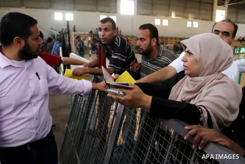 Palestinians wait for a travel permit to cross into Egypt through the Rafah border crossing after it was opened by Egyptian authorities for five days, in the southern Gaza Strip June 30, 2016. Photo by Abed Rahim Khatib