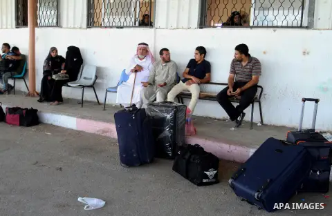Palestinians wait for a travel permit to cross into Egypt through the Rafah border crossing after it was opened by Egyptian authorities for five days, in the southern Gaza Strip June 30, 2016. Photo by Abed Rahim Khatib