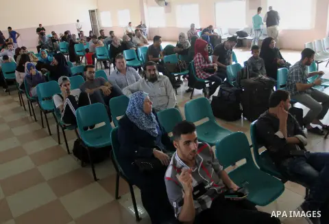 Palestinians wait for a travel permit to cross into Egypt through the Rafah border crossing after it was opened by Egyptian authorities for five days, in the southern Gaza Strip June 30, 2016. Photo by Abed Rahim Khatib