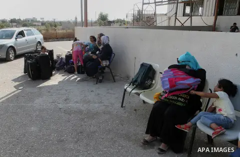 Palestinians wait for a travel permit to cross into Egypt through the Rafah border crossing after it was opened by Egyptian authorities for five days, in the southern Gaza Strip June 30, 2016. Photo by Abed Rahim Khatib