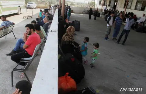 Palestinians wait for a travel permit to cross into Egypt through the Rafah border crossing after it was opened by Egyptian authorities for five days, in the southern Gaza Strip June 30, 2016. Photo by Abed Rahim Khatib