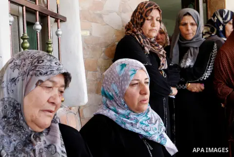 The family of Palestinian Mohammed Nasser Tarayra, who stabbed to death an Israeli teen in a Jewish settlement in the occupied West Bank on June 30,2016 is seen outside their family home in the village of Bani Naim, near...