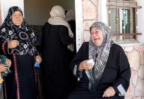 The family of Palestinian Mohammed Nasser Tarayra, who stabbed to death an Israeli teen in a Jewish settlement in the occupied West Bank on June 30,2016 is seen outside their family home in the village of Bani Naim, near...