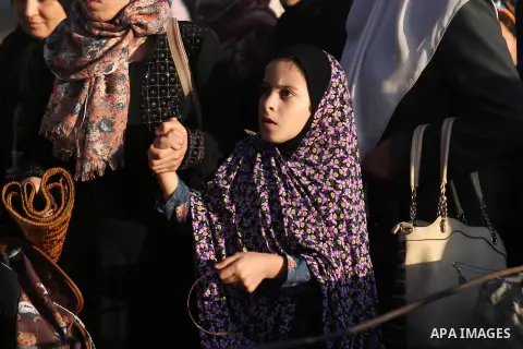 Palestinians wait to cross through Israeli Qalandia checkpoint as they make their way to attend the last Friday prayer of the holy fasting month of Ramadan in Jerusalem's al-Aqsa mosque, near the West Bank city of Ramall...