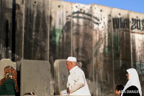 Palestinians wait to cross through Israeli Qalandia checkpoint as they make their way to attend the last Friday prayer of the holy fasting month of Ramadan in Jerusalem's al-Aqsa mosque, near the West Bank city of Ramall...