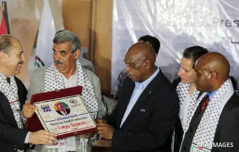 Chairman of the FIFA Monitoring Committee Israel-Palestine Tokyo Sexwale gestures as he receives a memorial gift from Ibraheem Abu Saleem, vice president of the Palestinian Football Association, in the northern Gaza Stri...
