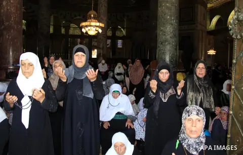 Palestinian women pray inside the Dome of the Rock mosque in Jerusalem's Al-Aqsa mosque compound during the last Friday prayers of the holy Muslim fasting month of Ramadan on July 1, 2016. Photo by Mahfouz Abu Turk