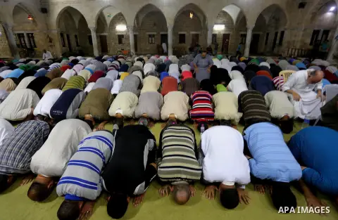 Palestinian Muslim worshippers pray overnight on July 2, 2016 at a Mosque in Gaza city on the occasion of Laylat al-Qadr which falls on the 27th day of the fasting month of Ramadan. Laylat al-Qadr, or Night of Destiny, m...