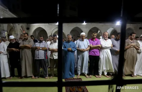 Palestinian Muslim worshippers pray overnight on July 2, 2016 at a Mosque in Gaza city on the occasion of Laylat al-Qadr which falls on the 27th day of the fasting month of Ramadan. Laylat al-Qadr, or Night of Destiny, m...