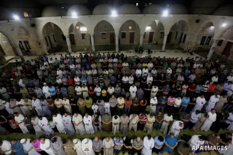 Palestinian Muslim worshippers pray overnight on July 2, 2016 at a Mosque in Gaza city on the occasion of Laylat al-Qadr which falls on the 27th day of the fasting month of Ramadan. Laylat al-Qadr, or Night of Destiny, m...
