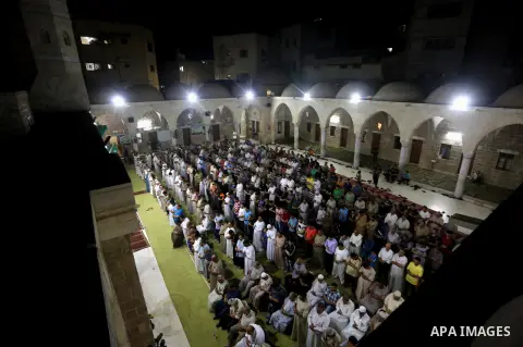 Palestinian Muslim worshippers pray overnight on July 2, 2016 at a Mosque in Gaza city on the occasion of Laylat al-Qadr which falls on the 27th day of the fasting month of Ramadan. Laylat al-Qadr, or Night of Destiny, m...