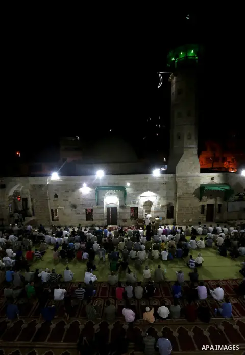 Palestinian Muslim worshippers pray overnight on July 2, 2016 at a Mosque in Gaza city on the occasion of Laylat al-Qadr which falls on the 27th day of the fasting month of Ramadan. Laylat al-Qadr, or Night of Destiny, m...
