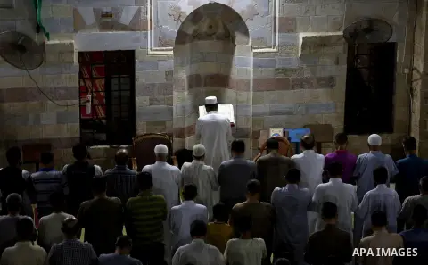 Palestinian Muslim worshippers pray overnight on July 2, 2016 at a Mosque in Gaza city on the occasion of Laylat al-Qadr which falls on the 27th day of the fasting month of Ramadan. Laylat al-Qadr, or Night of Destiny, m...