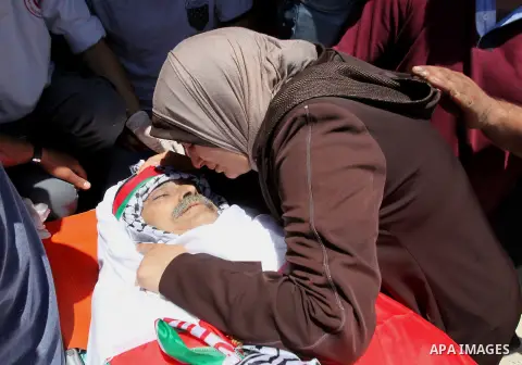 Relatives of Palestinian Tayseer Habash, who died from tear gas fired by Israeli security forces during clashes, mourn next to his body during his funeral on July 2, 2016 in the West Bank city of Nablus. Habash, 63, died...