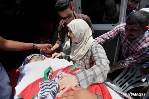 The mother of Palestinian Tayseer Habash, who died from tear gas fired by Israeli security forces during clashes, mourns next to his body during his funeral on July 2, 2016 in the West Bank city of Nablus. Habash, 63, di...