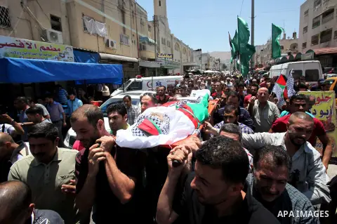 Mourners carry the body of Palestinian Tayseer Habash, who died from tear gas fired by Israeli security forces during clashes, during his funeral on July 2, 2016 in the West Bank city of Nablus. Habash, 63, died on July...