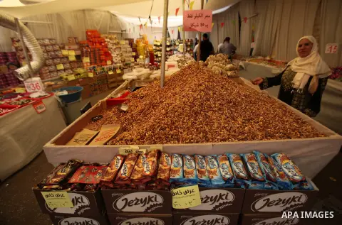 Palestinians shop at a market ahead of the Eid al-Fitr holiday, in the West Bank city of Nablus, on July 3, 2016. Eid al-Fitr marks the end of Muslim's holy fasting month of Ramadan when faithfuls abstain from eating, dr...