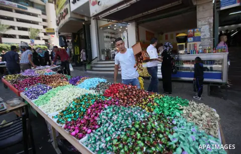 Palestinians shop at a market ahead of the Eid al-Fitr holiday, in the West Bank city of Nablus, on July 3, 2016. Eid al-Fitr marks the end of Muslim's holy fasting month of Ramadan when faithfuls abstain from eating, dr...