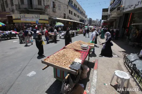 Palestinians shop at a market ahead of the Eid al-Fitr holiday, in the West Bank city of Nablus, on July 3, 2016. Eid al-Fitr marks the end of Muslim's holy fasting month of Ramadan when faithfuls abstain from eating, dr...