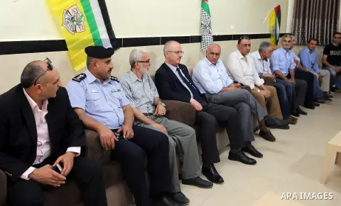 Palestinian Prime Minister Rami Hamdallah visits the mourning tent of a member of Palestinian security forces Annan Tabouk, in the West Bank city of Nablus, on July 03, 2016. Photo by Prime Minister Office
