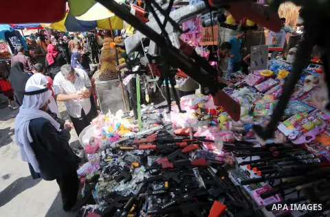 Palestinians shop at a market ahead of the Eid al-Fitr holiday, in Gaza city, on July 4, 2016. Eid al-Fitr marks the end of Muslim's holy fasting month of Ramadan when faithfuls abstain from eating, drinking, smoking and...
