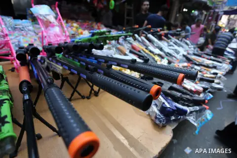 Palestinians shop at a market ahead of the Eid al-Fitr holiday, in Gaza city, on July 4, 2016. Eid al-Fitr marks the end of Muslim's holy fasting month of Ramadan when faithfuls abstain from eating, drinking, smoking and...