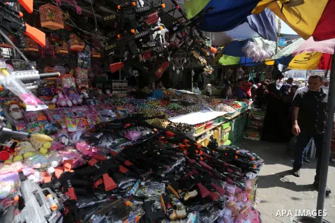 Palestinians shop at a market ahead of the Eid al-Fitr holiday, in Gaza city, on July 4, 2016. Eid al-Fitr marks the end of Muslim's holy fasting month of Ramadan when faithfuls abstain from eating, drinking, smoking and...