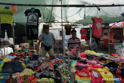 Palestinians shop at a market ahead of the Eid al-Fitr holiday, in Nuseirat refugee camp in the central Gaza Strip, on July 4, 2016. Eid al-Fitr marks the end of Muslim's holy fasting month of Ramadan when faithfuls abst...