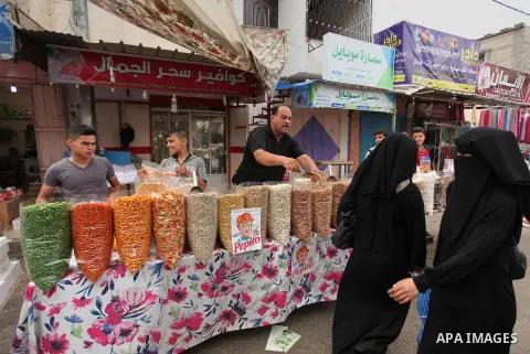 Palestinians shop at a market ahead of the Eid al-Fitr holiday, in Nuseirat refugee camp in the central Gaza Strip, on July 4, 2016. Eid al-Fitr marks the end of Muslim's holy fasting month of Ramadan when faithfuls abst...