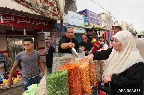 Palestinians shop at a market ahead of the Eid al-Fitr holiday, in Nuseirat refugee camp in the central Gaza Strip, on July 4, 2016. Eid al-Fitr marks the end of Muslim's holy fasting month of Ramadan when faithfuls abst...