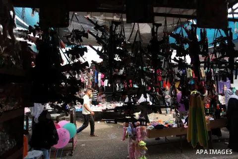 Palestinians shop at a market ahead of the Eid al-Fitr holiday, in Nuseirat refugee camp in the central Gaza Strip, on July 4, 2016. Eid al-Fitr marks the end of Muslim's holy fasting month of Ramadan when faithfuls abst...