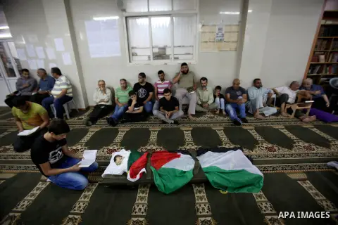 Mourners gather around the body of Rayyan Shreem"3 years", a Palestinian child who was killed in the Istanbul airport attack blamed on the Islamic State (IS) group on June 28, during his funeral in the West Bank town of...
