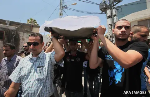Mourners carry the body of Rayyan Shreem"3 years", a Palestinian child who was killed in the Istanbul airport attack blamed on the Islamic State (IS) group on June 28, during his funeral in the West Bank town of Qalqilya...