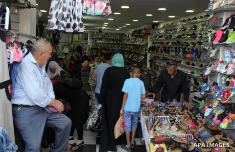 Palestinians shop at a market ahead of the Eid al-Fitr holiday, in Jerusalem old city, on July 3, 2016. Eid al-Fitr marks the end of Muslim's holy fasting month of Ramadan when faithfuls abstain from eating, drinking, sm...