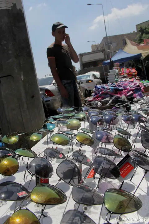 Palestinians shop at a market ahead of the Eid al-Fitr holiday, in Jerusalem old city, on July 3, 2016. Eid al-Fitr marks the end of Muslim's holy fasting month of Ramadan when faithfuls abstain from eating, drinking, sm...