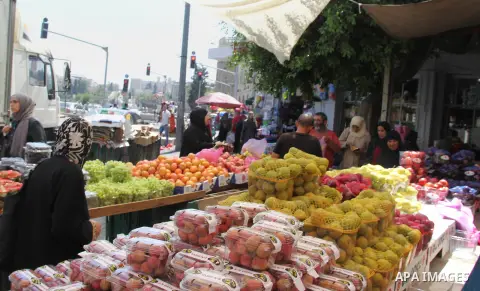 Palestinians shop at a market ahead of the Eid al-Fitr holiday, in Jerusalem old city, on July 3, 2016. Eid al-Fitr marks the end of Muslim's holy fasting month of Ramadan when faithfuls abstain from eating, drinking, sm...