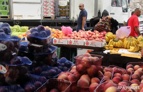Palestinians shop at a market ahead of the Eid al-Fitr holiday, in Jerusalem old city, on July 3, 2016. Eid al-Fitr marks the end of Muslim's holy fasting month of Ramadan when faithfuls abstain from eating, drinking, sm...