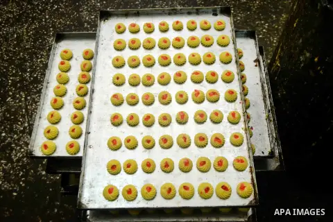 Egyptian bakers prepare date-filled mini cakes traditional for the Eid al-Fitr a three-day holiday that marks the end of the fasting month of Ramadan, at shop in Cairo, Egypt, on July 4, 2016, as Muslims the world over p...