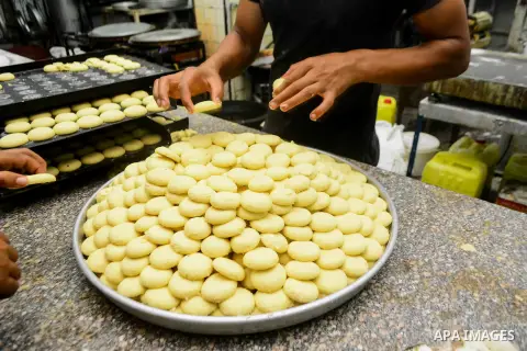 Egyptian bakers prepare date-filled mini cakes traditional for the Eid al-Fitr a three-day holiday that marks the end of the fasting month of Ramadan, at shop in Cairo, Egypt, on July 4, 2016, as Muslims the world over p...