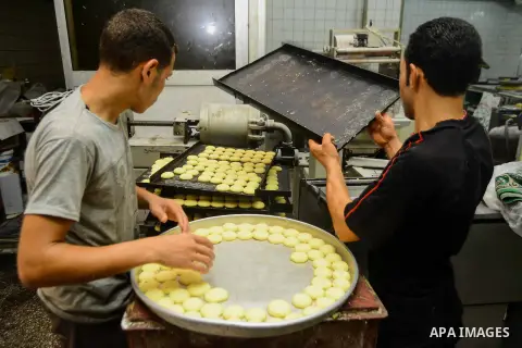 Egyptian bakers prepare date-filled mini cakes traditional for the Eid al-Fitr a three-day holiday that marks the end of the fasting month of Ramadan, at shop in Cairo, Egypt, on July 4, 2016, as Muslims the world over p...
