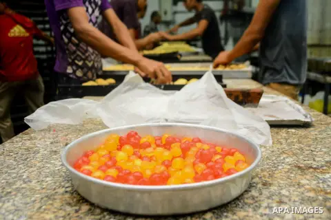 Egyptian bakers prepare date-filled mini cakes traditional for the Eid al-Fitr a three-day holiday that marks the end of the fasting month of Ramadan, at shop in Cairo, Egypt, on July 4, 2016, as Muslims the world over p...