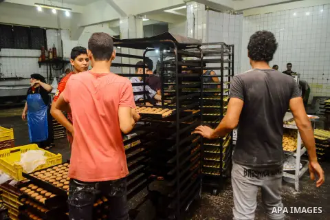 Egyptian bakers prepare date-filled mini cakes traditional for the Eid al-Fitr a three-day holiday that marks the end of the fasting month of Ramadan, at shop in Cairo, Egypt, on July 4, 2016, as Muslims the world over p...