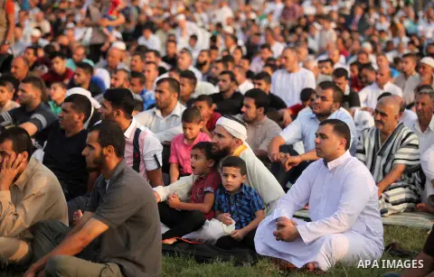 Palestinians attend the morning prayers for Eid al-Fitr celebrations, which marks the end of the holy fasting month of Ramadan, in Gaza City July 6, 2016. Photo by Ashraf Amra