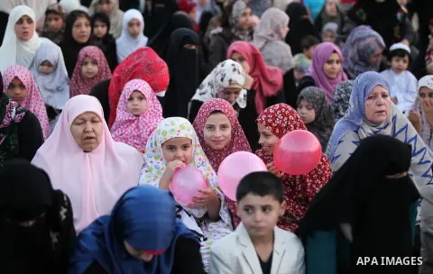 Palestinians attend the morning prayers for Eid al-Fitr celebrations, which marks the end of the holy fasting month of Ramadan, in Gaza City July 6, 2016. Photo by Ashraf Amra