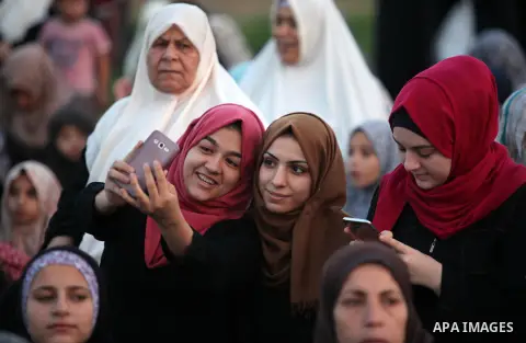 Palestinians attend the morning prayers for Eid al-Fitr celebrations, which marks the end of the holy fasting month of Ramadan, in Gaza City July 6, 2016. Photo by Ashraf Amra