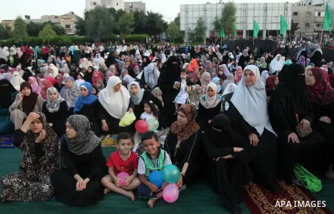 Palestinians attend the morning prayers for Eid al-Fitr celebrations, which marks the end of the holy fasting month of Ramadan, in Gaza City July 6, 2016. Photo by Ashraf Amra